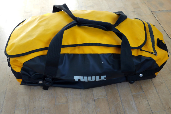 Thule_Chasm-Medium_water-resistant-convertible-duffel-bag_Zinnia-yellow_compressed-worn