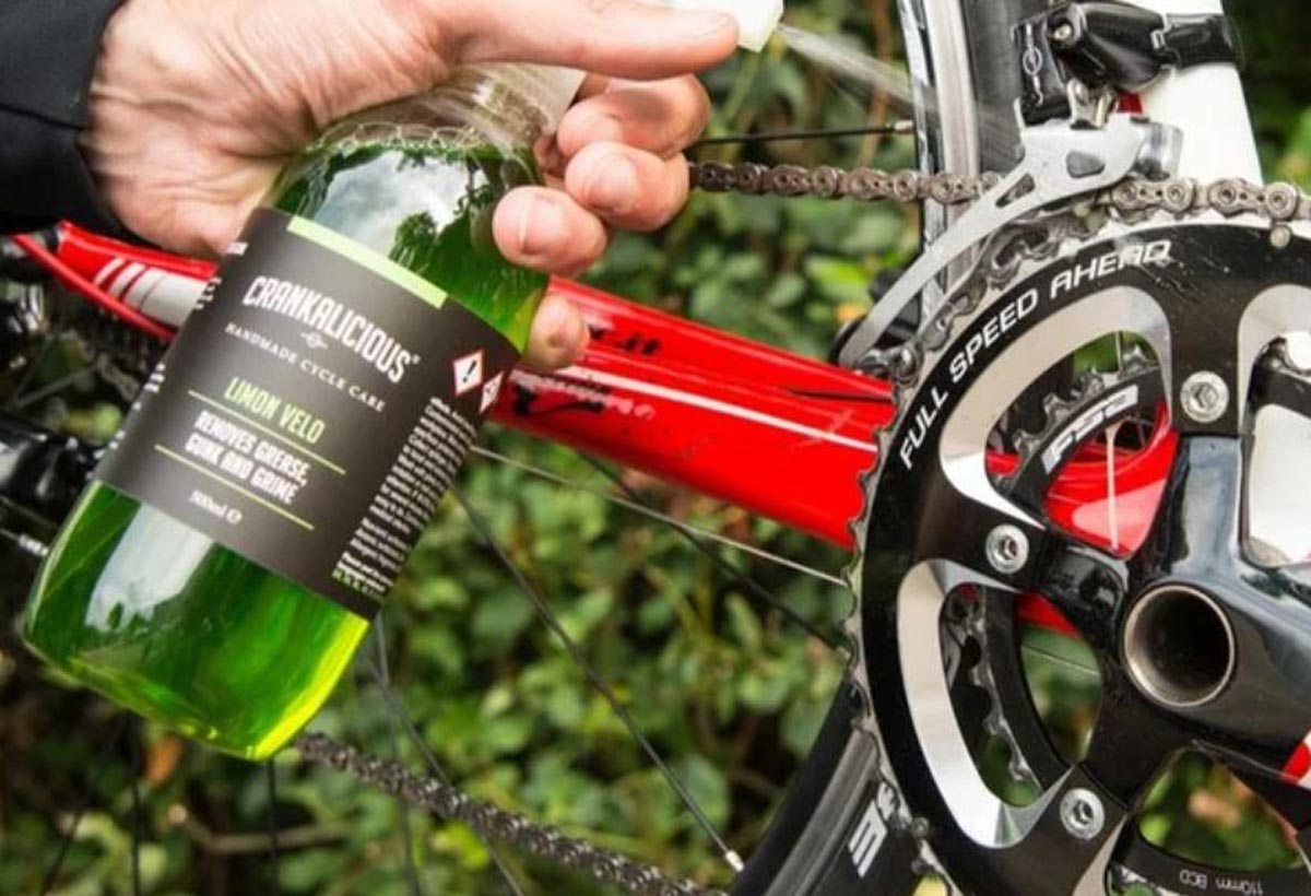 chain cleaner being sprayed directly on a bicycle drivetrain