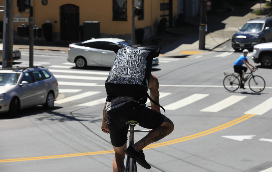 Ortlieb custom bags benefit Cycles of Change rolling in the street