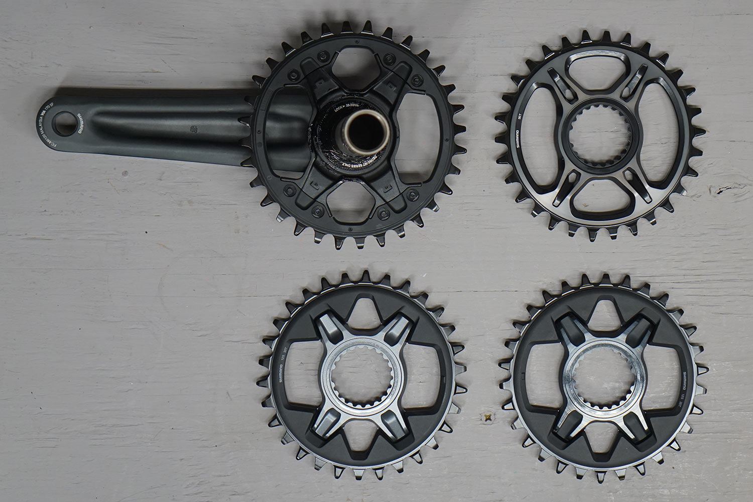 shimano 12 speed chainrings for deore, slx, xt and xtr shown side by side in a comparison