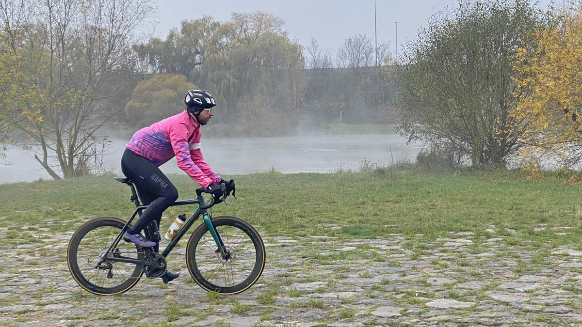 Exclusive Review: Rapha Pro Team Lightweight Gore-Tex Jacket printed in pink Technicolor, extra full color Shakedry visibility, riverside