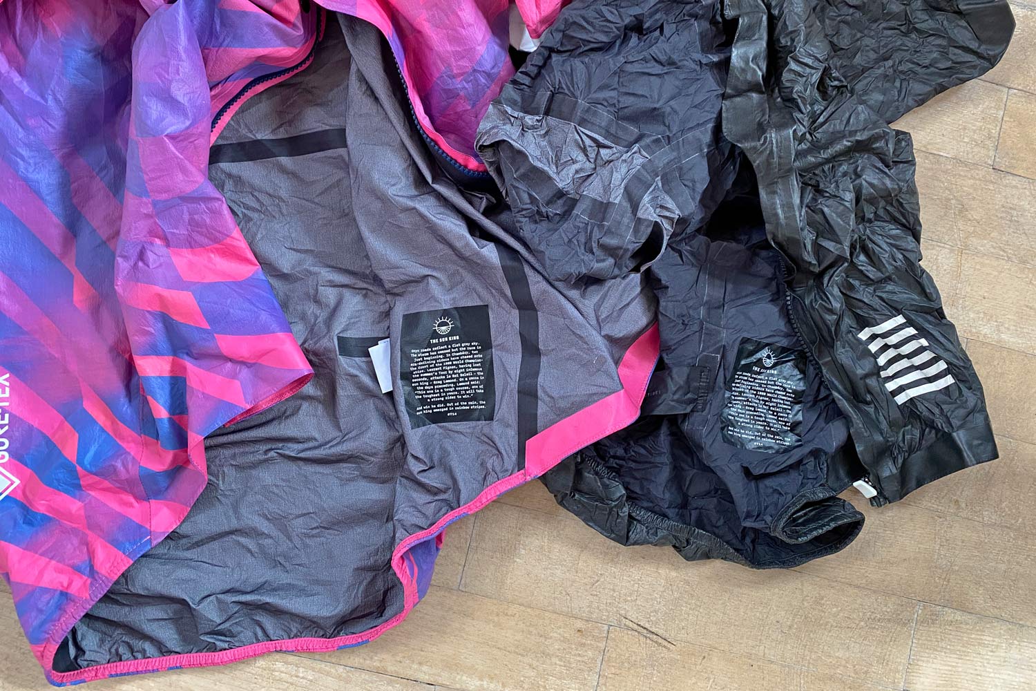 Exclusive Review: Rapha Pro Team Lightweight Gore-Tex Jacket printed in pink Technicolor, extra full color Shakedry visibility, pink vs. black