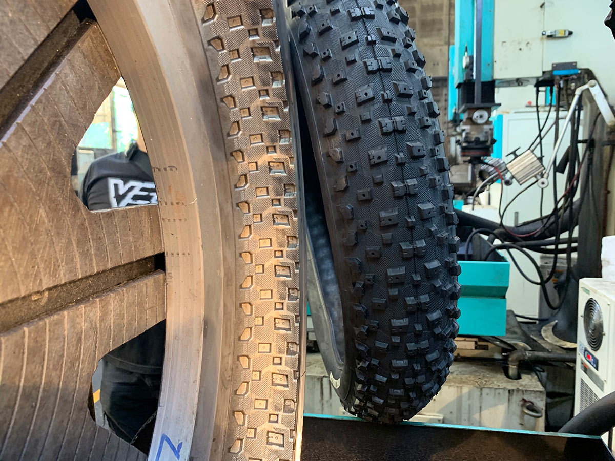 vee mountain bike tire next to the mold used to make it