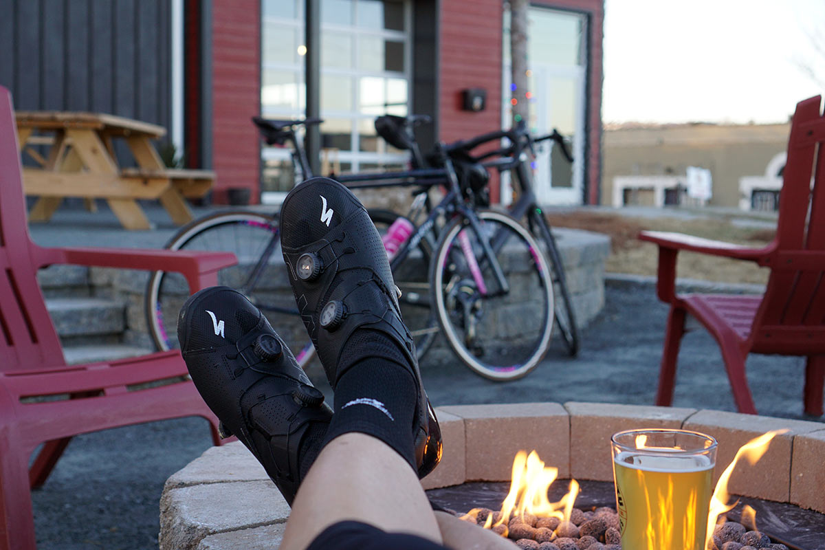 feet up on a fire pit wearing the specialized ares road cycling shoes