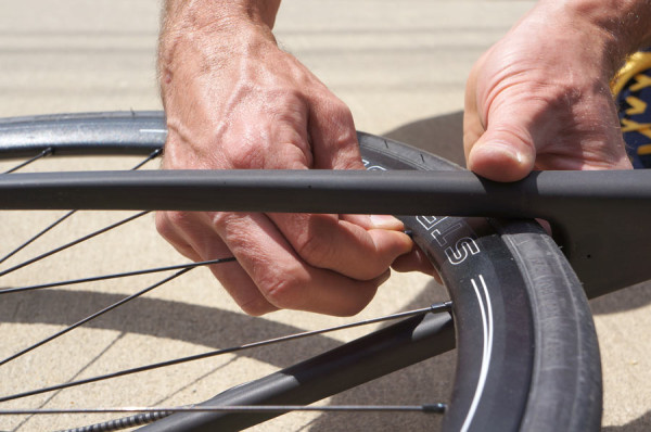 how to true a bicycle wheel on the road or trail without tools so you can keep riding