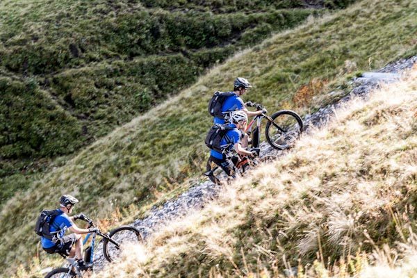 DT Swiss Hybrid E-MTB wheels, riders climbing