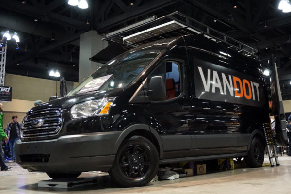 VanDOit custom Ford Transit adventure van with bed and built in bike rack