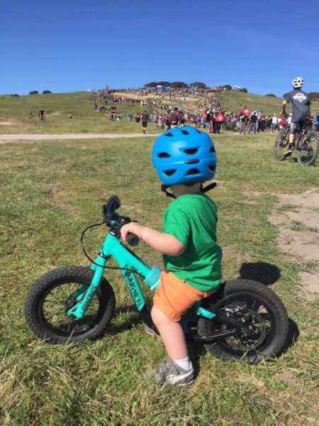 bikerumor pic of the day toddler watching the dual slalom race at Sea Otter Bike Race.