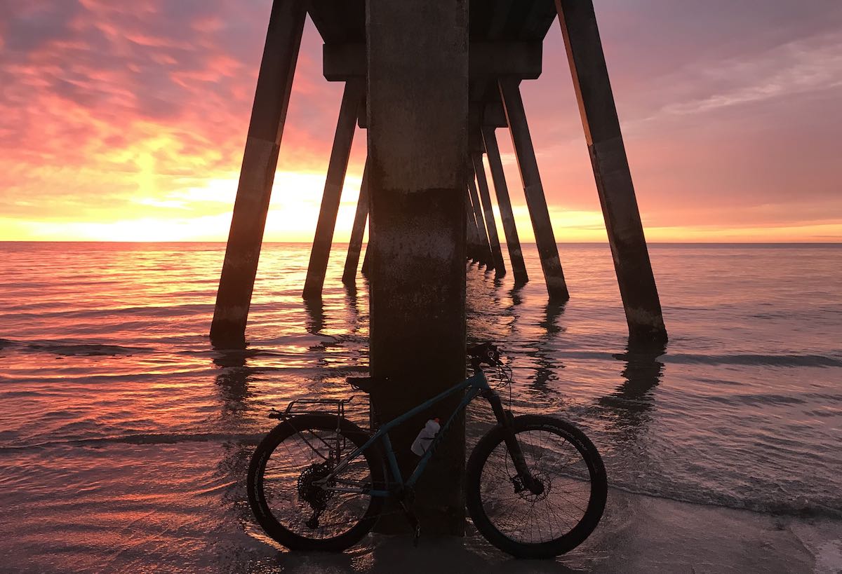 bikerumor pic of the day bicycling on the beach at sunset in Wrightsville Beach, North Carolina.