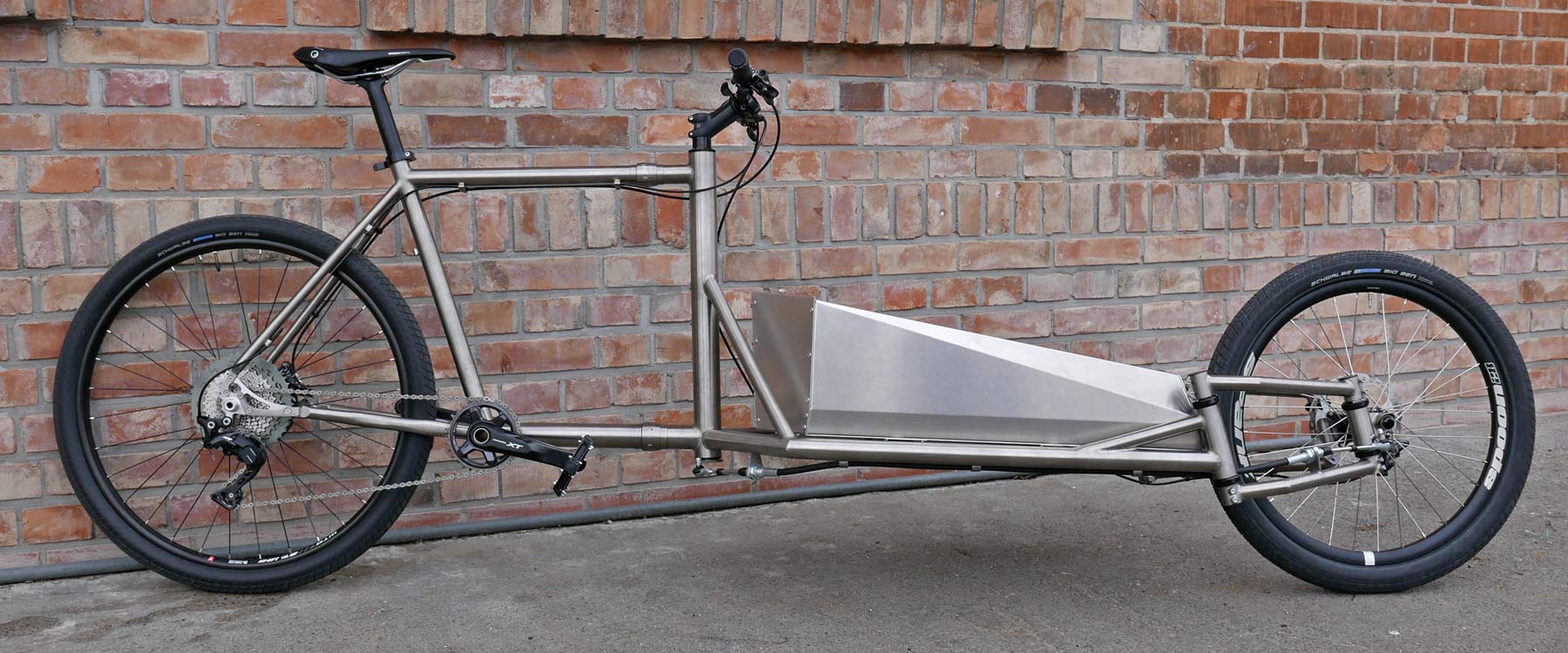 Catan titanium Cargobike lightweight mixed-surface gravel cargo bike, unique linkage arm steering engineered flex