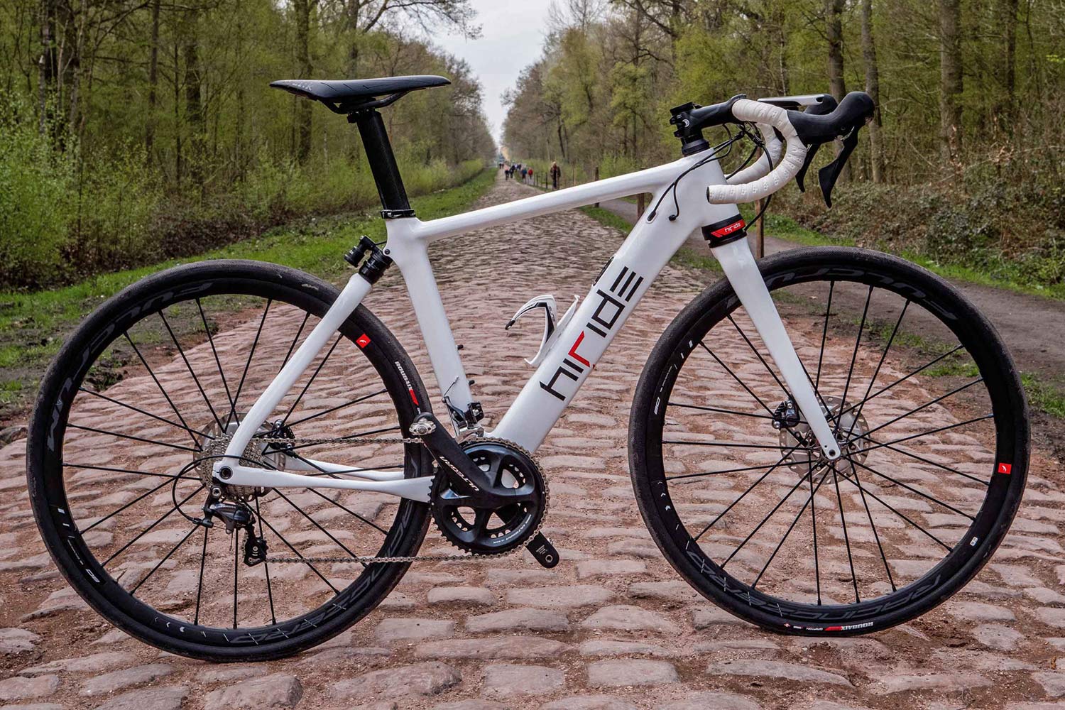 HiRide rides their own disc brake full suspension road bike over Roubaix cobbles Bikerumor