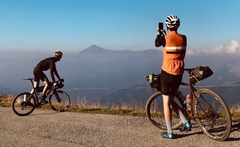 bikerumor pic of the day two cyclists at the top of Col de Tende on the borders of France and Italy.
