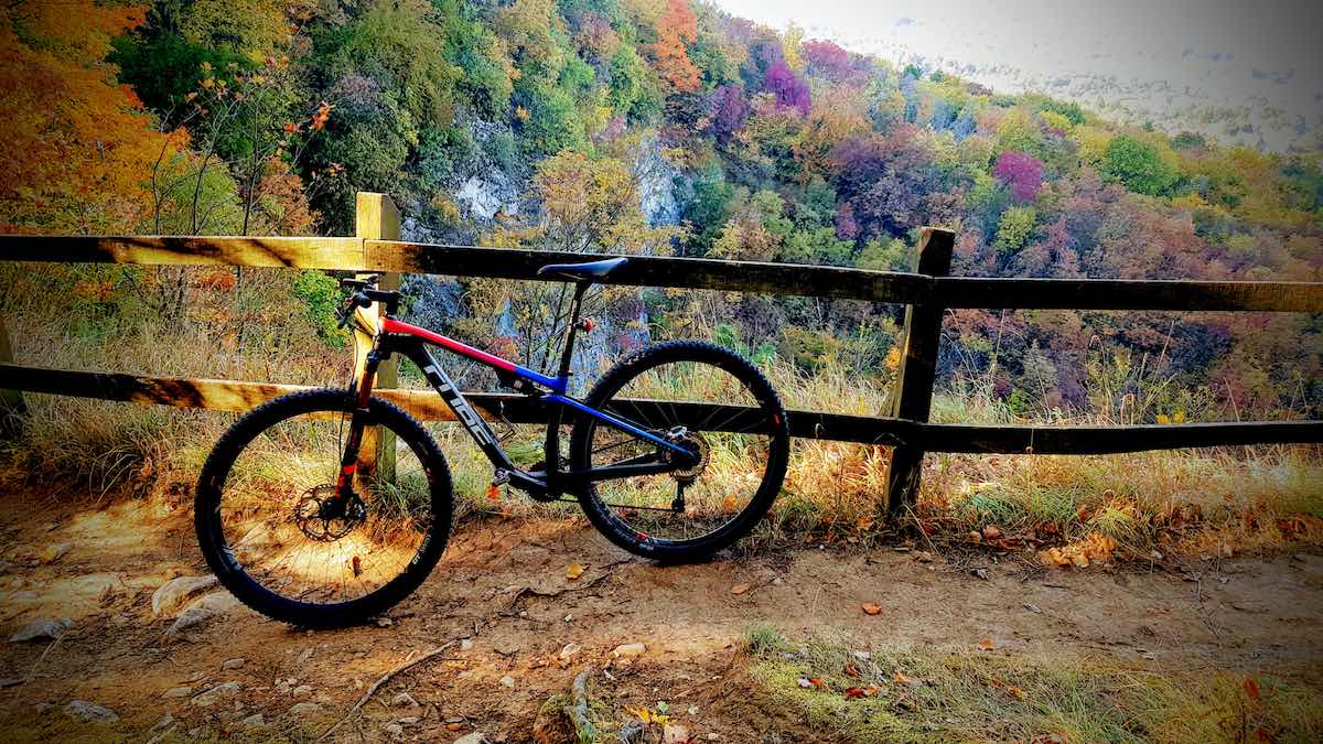 bikerumor pic of the day cube mountain bike beside a wooden fence with trees in different autumn colors in the background, close to Solymár Hungary.