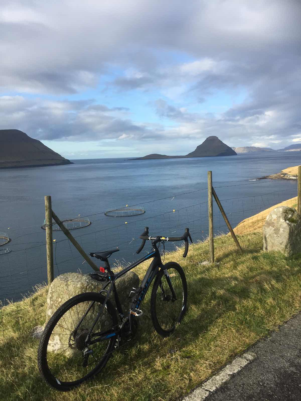 bikerumor pic of the day black Giant Toughroad bicycle looking out over the water on streymoy island of the Faroe Islands.