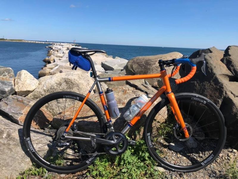 bikerumor pic of the day independent fabrication bike in front of boulders by the ocean.
