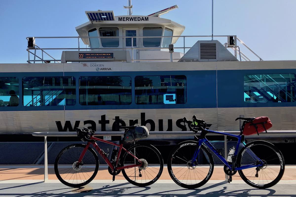 bikerumor pic of the day overnight bike packing trip, two bicycles in front of a waterbus or ferry