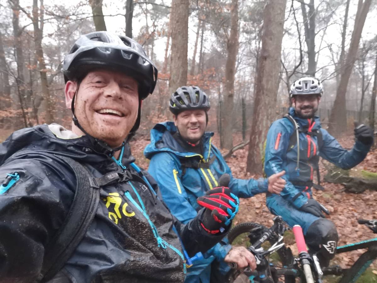 bikerumor pic of the day three mountain bike riders in dirt suits covered in mud and rain in the winter in Groesbeek, Netherlands.