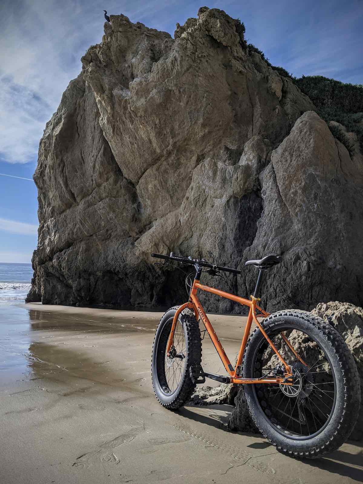 bikerumor pic of the day surly fat bike on el matador state beach in malibu california bike on the beach under a large rock