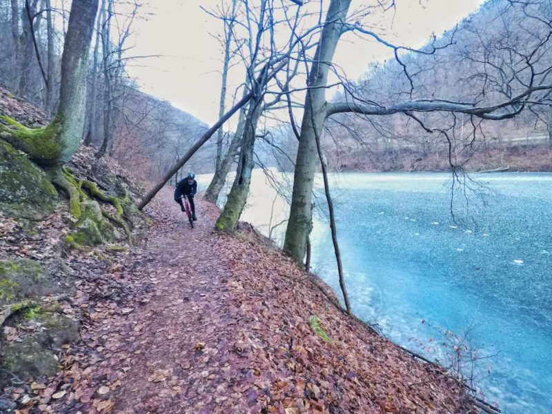 bikerumor pic of the day Lillafüred-Hungary single track trail on the bank of a frozen blue river in winter.