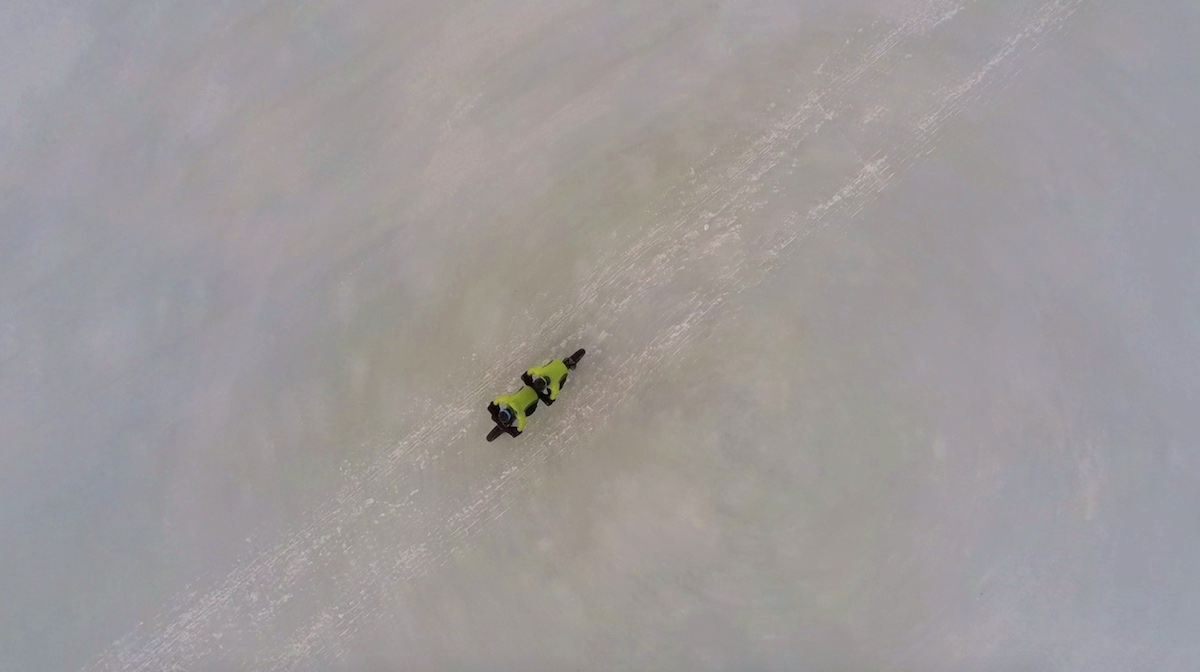 bikerumor pic of the day aerial view of tandem fat bike riders crossing the snowy icy plain in Gello, Norway.