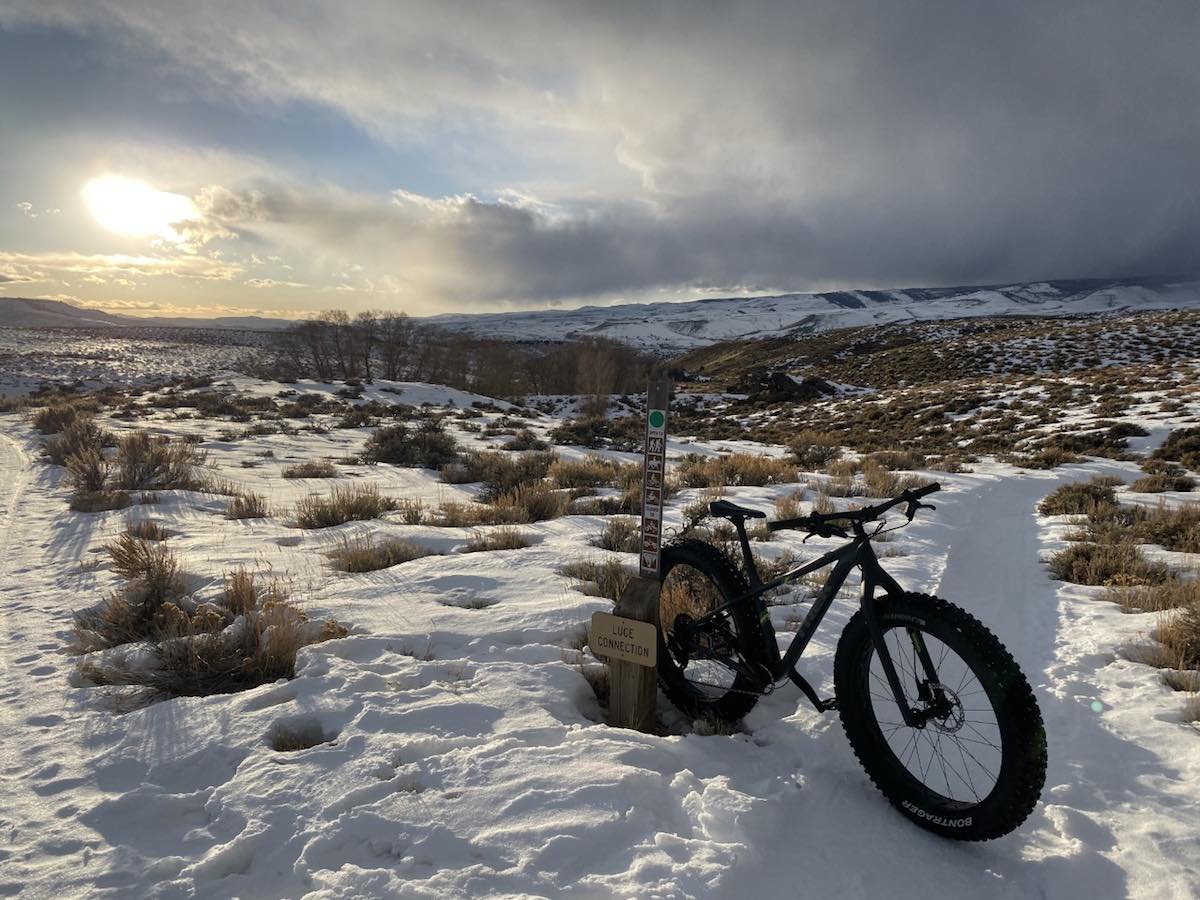 bikerumor pic of the day hartman rocks trail near gunnison colorado. fat tire mountain bike sitting in snow on a wide open valley covered in snow and grassland.