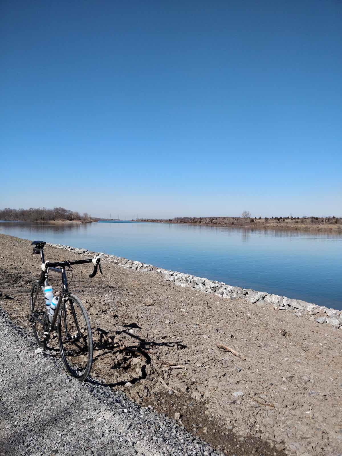 bikerumor pic of the day bicycle at the side of a canal with bare rocky land on either side in port colborne ontario canada.