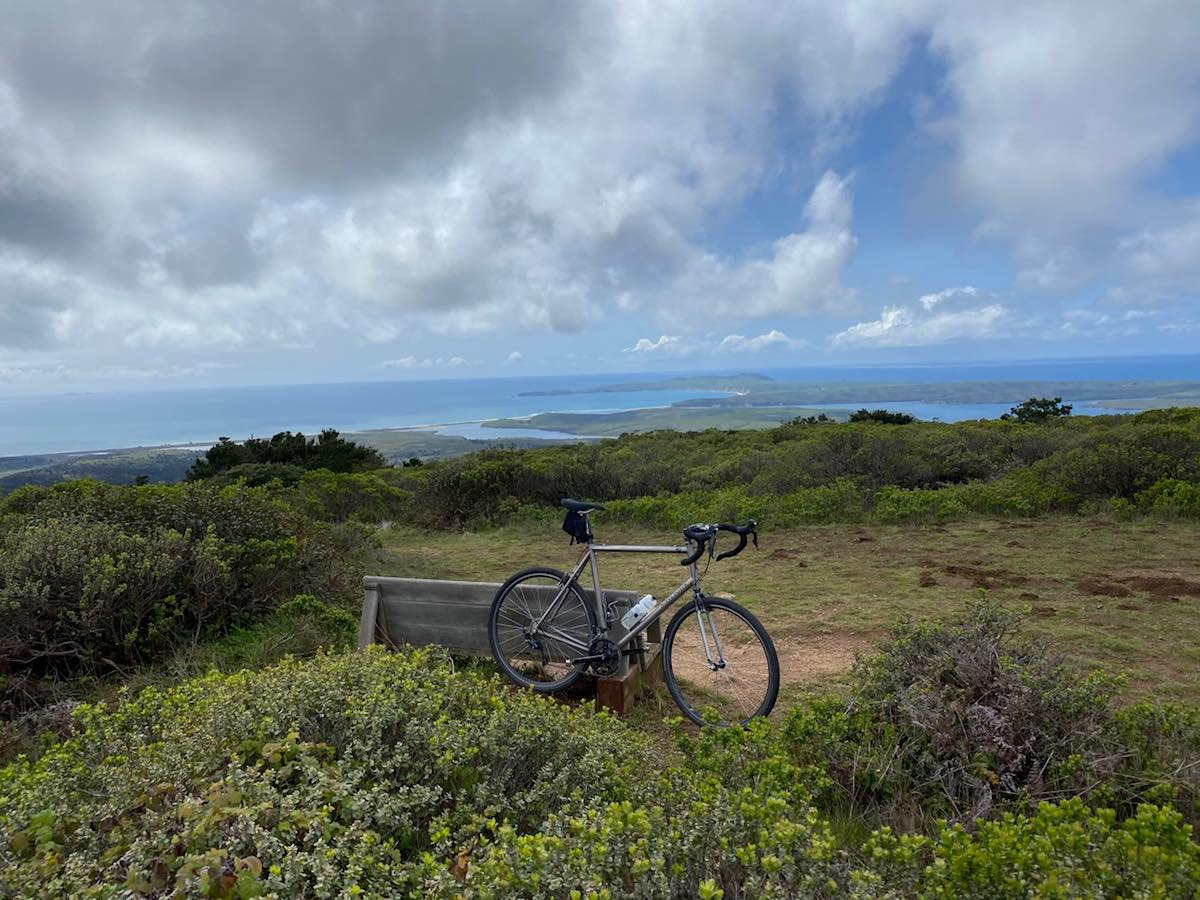 bikerumor pic of the day mountain bike sitting among the bushes with a seashore in the distance at point reyes national seashore, california.