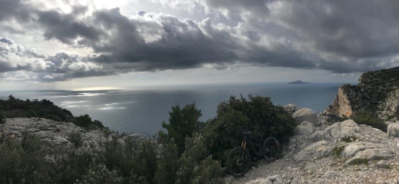 bikerumor pic of the day ripmo mountain bike posed near some scrub bushes on the edge of a cliff overlooking a bay in the Parc National des Calangues, southern France, near marseille.