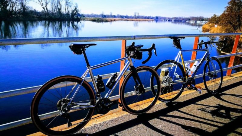 bikerumor pic of the day two road bikes leaning against a metal railing overlooking a lake called the buiten liede in north holland netherlands.
