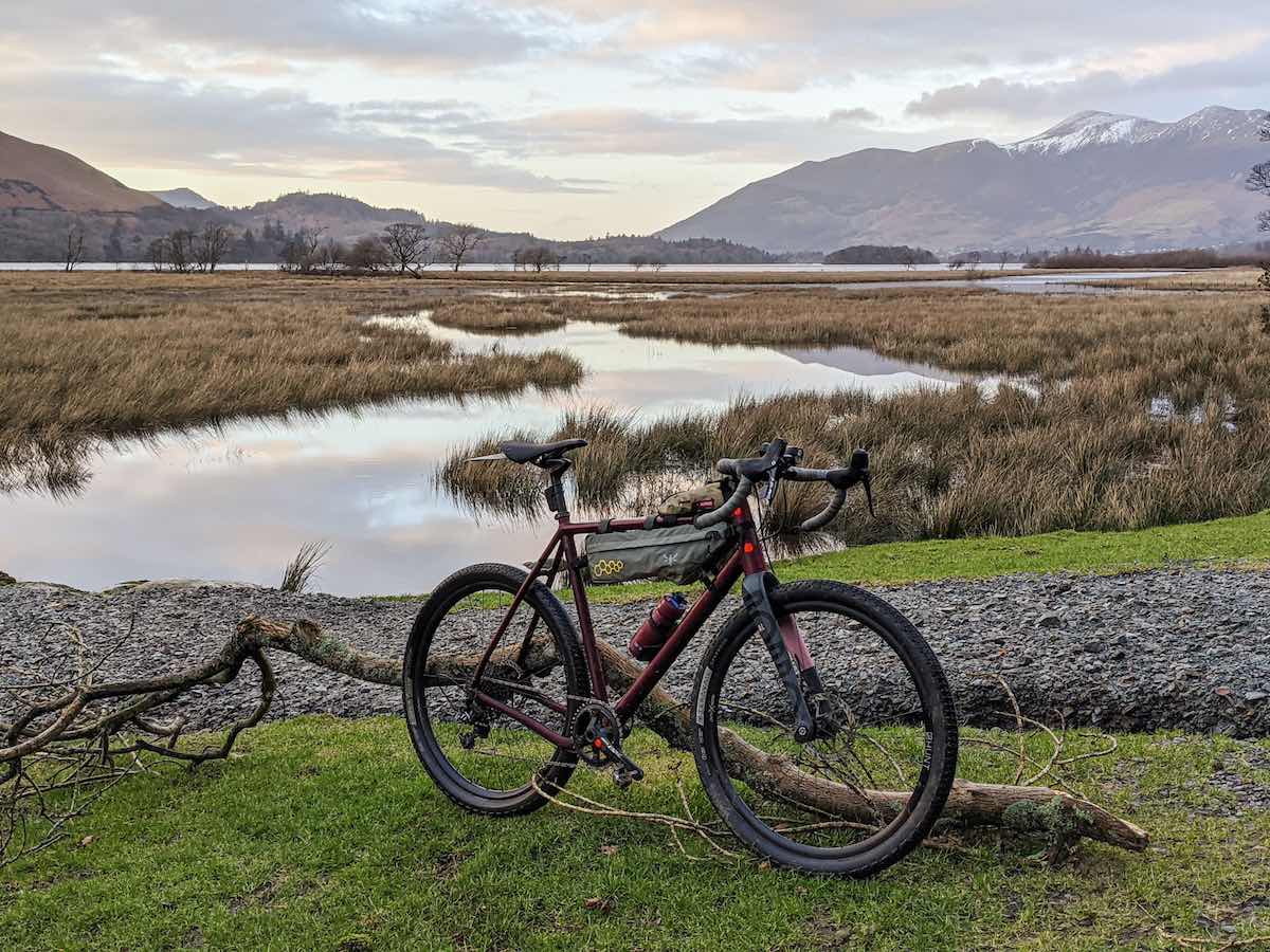 bikerumor pic of the day ruut bicycle on a grassy landing in front of a lake surrounded by wetlands and skiddaw mountain in the distance.