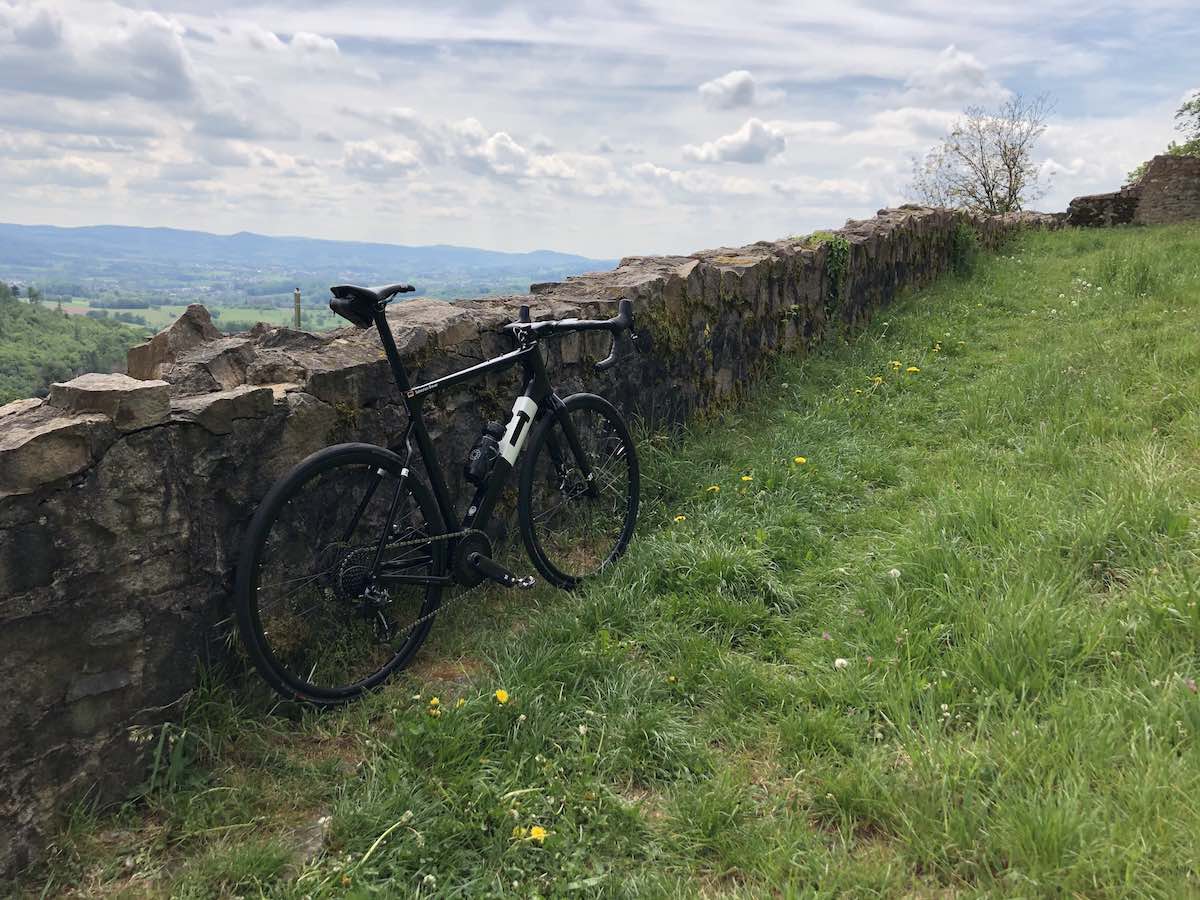 bikerumor pic of the day 3T road bike leaning against a stone fence in a green field at the top of a low mountain in the odenwald of germany.