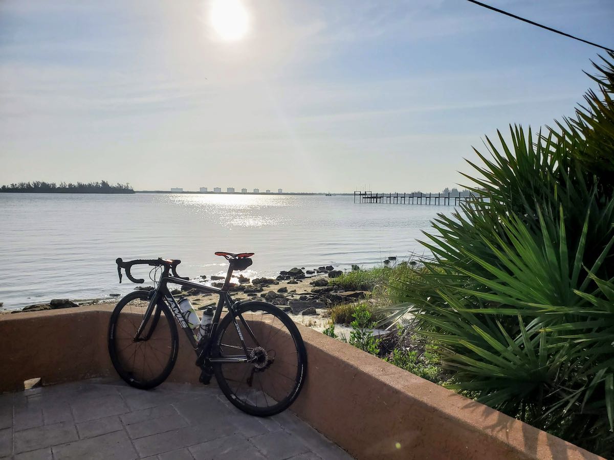 bikerumor pic of the day jamis bicycle overlooking port saint lucie with palms on one side and a bridge in the distance.