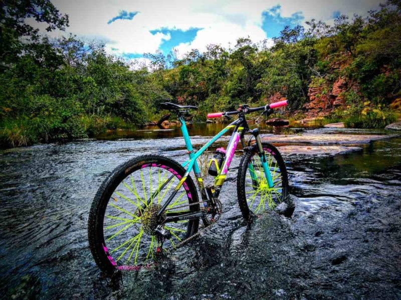 bikerumor pic of the day harlequin bicycle standing in running water surrounded by lush green trees in brazil