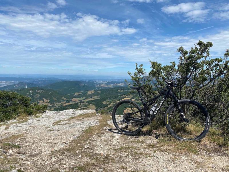 bikerumor pic of the day Dieulefit, Southern France. santa cruz on top of a rocky hill overlooking green valley.