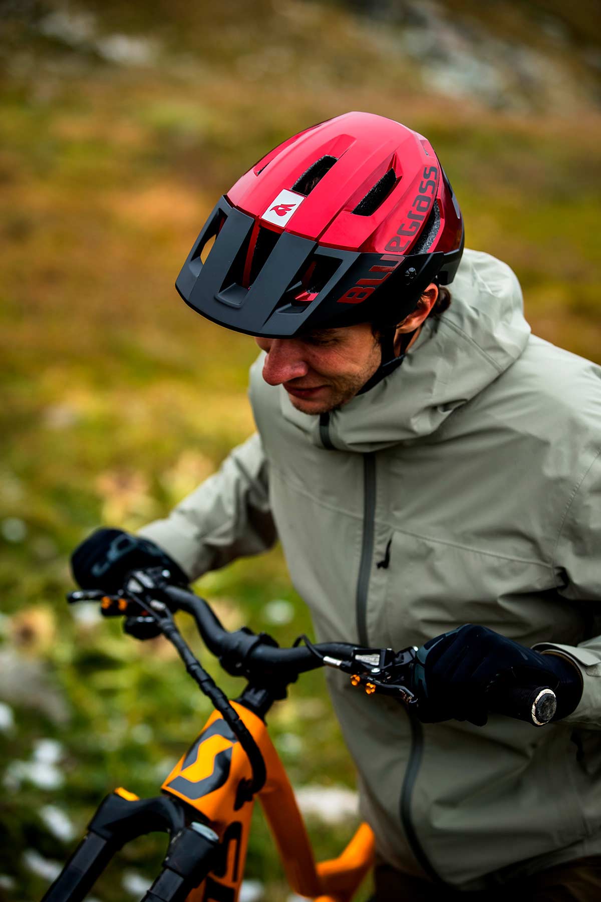 modeling bluegrass rogue core mips mtb helmet for enduro pushing bike up hill