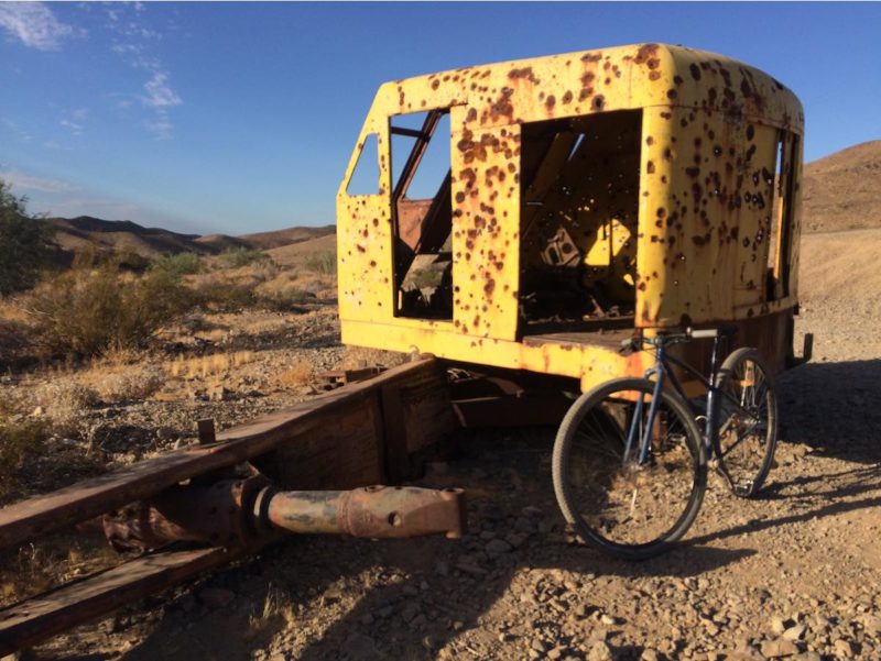 bikerumor pic of the day bicycle is leaning against an old rusty piece of machinery in yuma arizona.