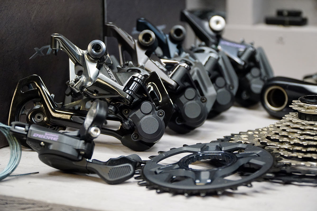 Shimano 12 speed mountain bike group component comparison with all four derailleurs lined up