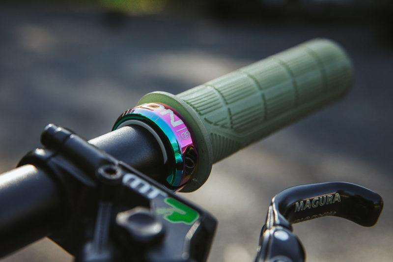 ergon oil slick rainbow prism lock on grips upgrade shown on a mountain bike handlebar