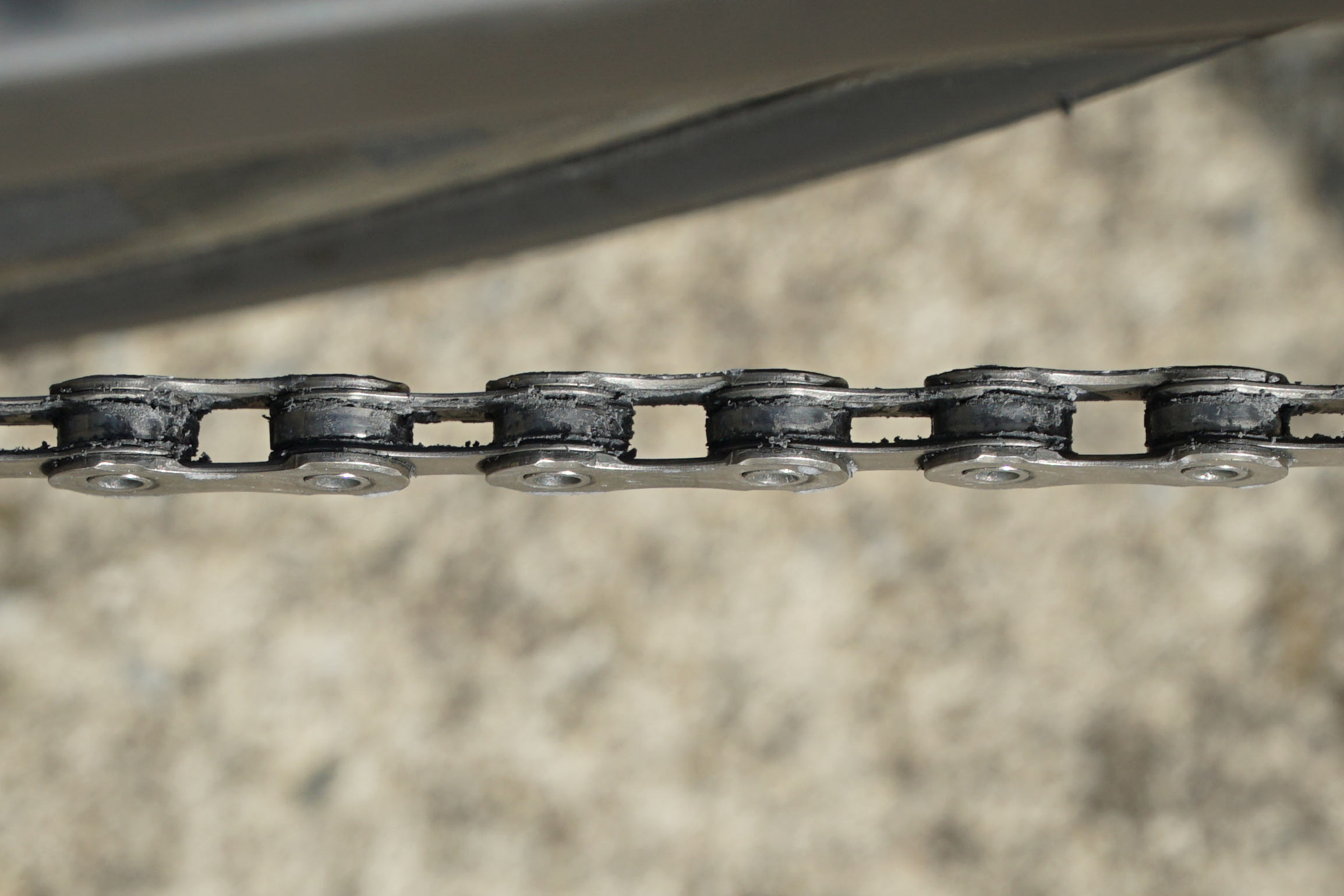 ceramicspeed ufo drip chain coating wax lube shown on chain closeup