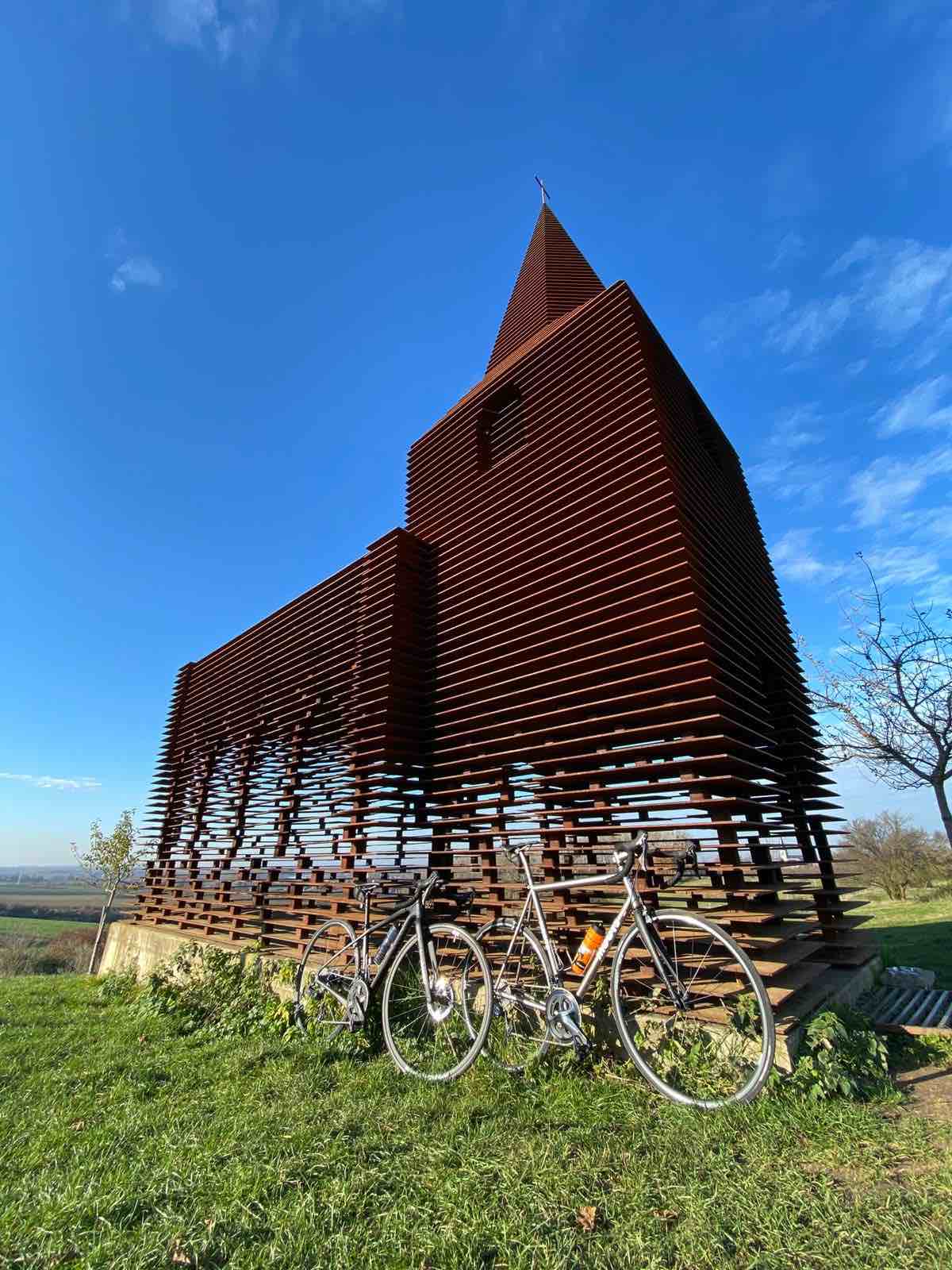 bikerumor pic of the day two bicycles leaning against a metal church sculpture in borgloon belgium by the artists GIJS VAN VAERENBERGH