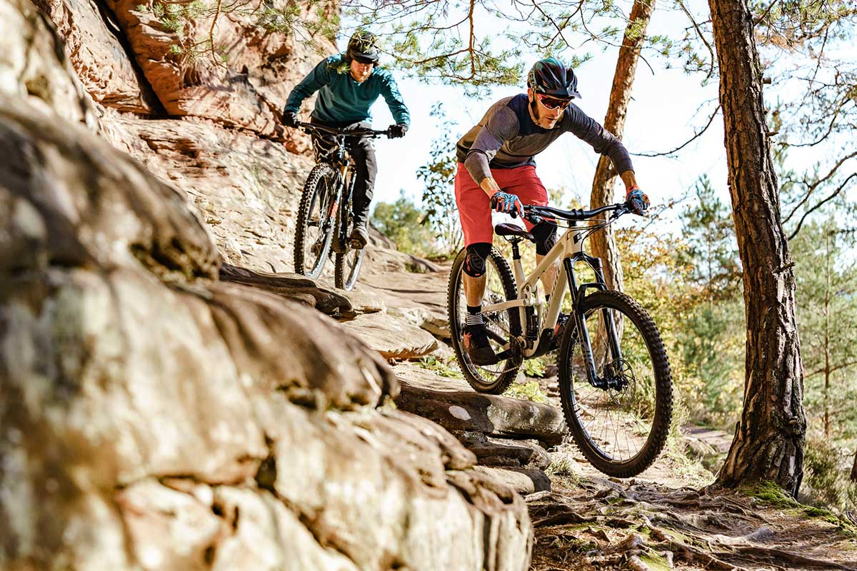 2021 propain hugene riding shots rocky trail two male mountain bikers