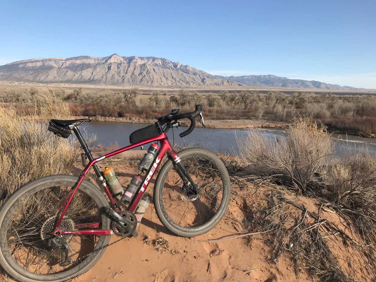 bikerumor pic of the day a red trek bicycle is atop a sandy ridge overlooking the rio grande river and the Bosque in Albuquerque new mexico.