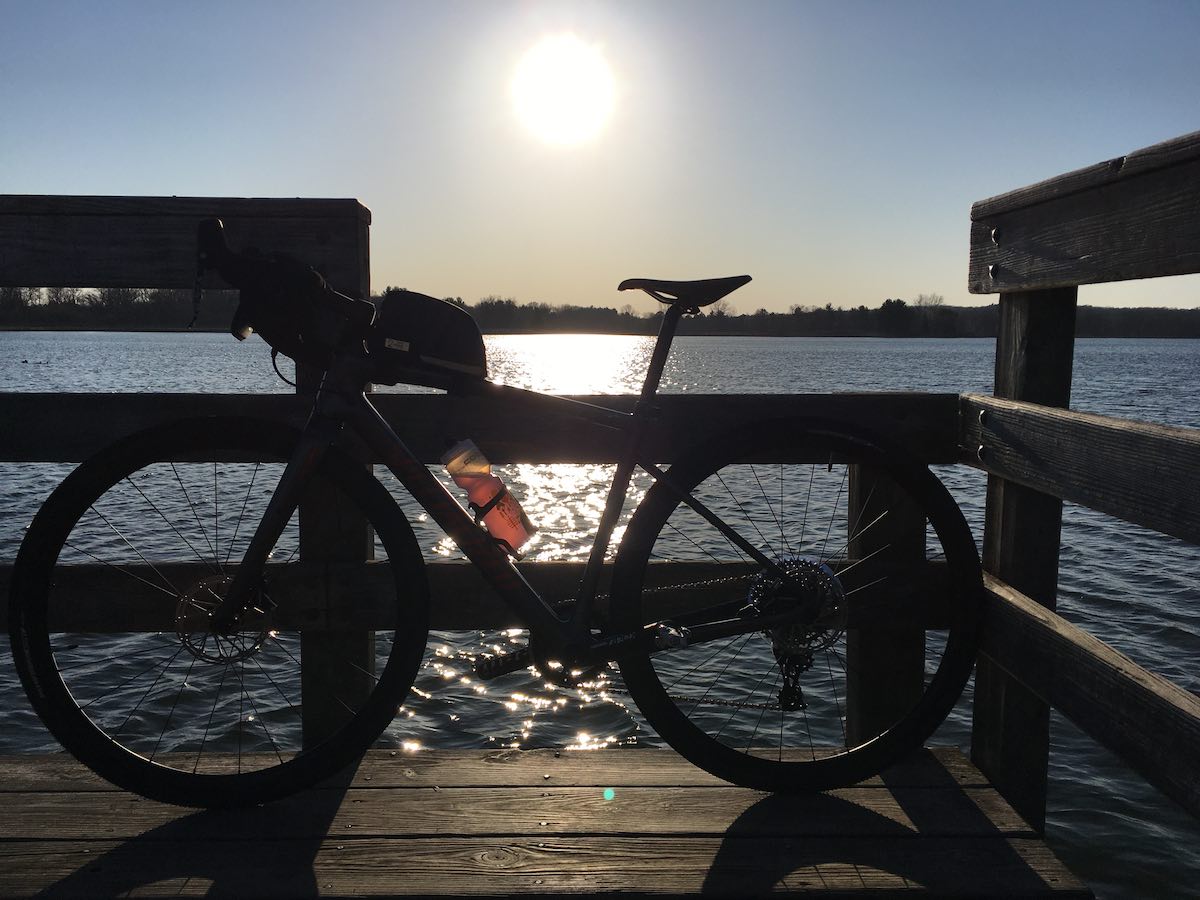 bikerumor pic of the day a bicycle is on the end of a pier and is photographed with the sun in the background so that the bike is in profile.