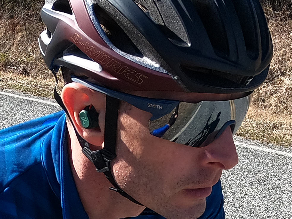 jaybird vista pro wireless earbuds for cyclists shown on a rider