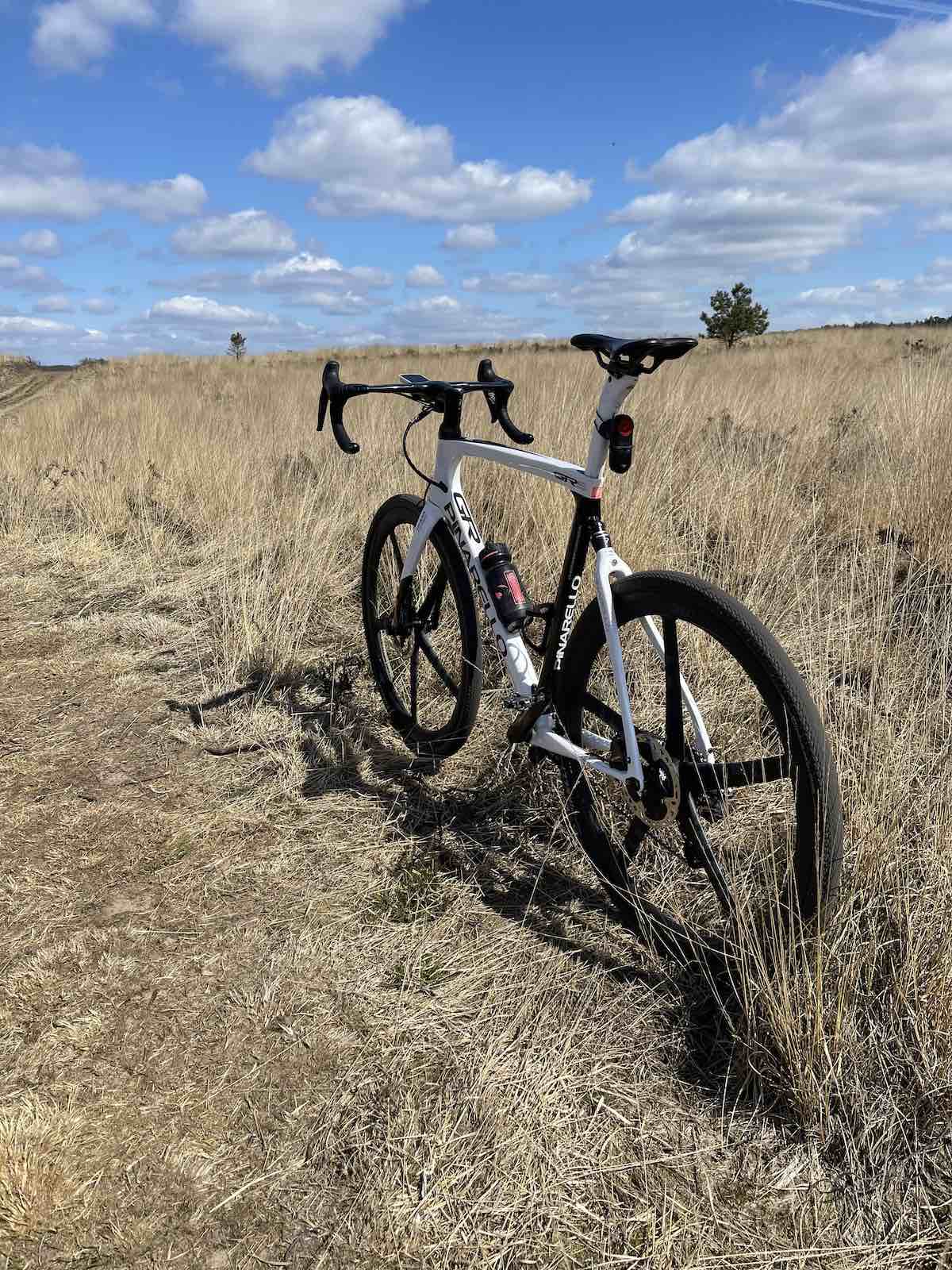 bikerumor pic of the day a pinarello bicycle is on a gravel path amidst golden grassy field with a blue sky dotted with fluffy white clouds in the Loenermark on the dutch veluwe.