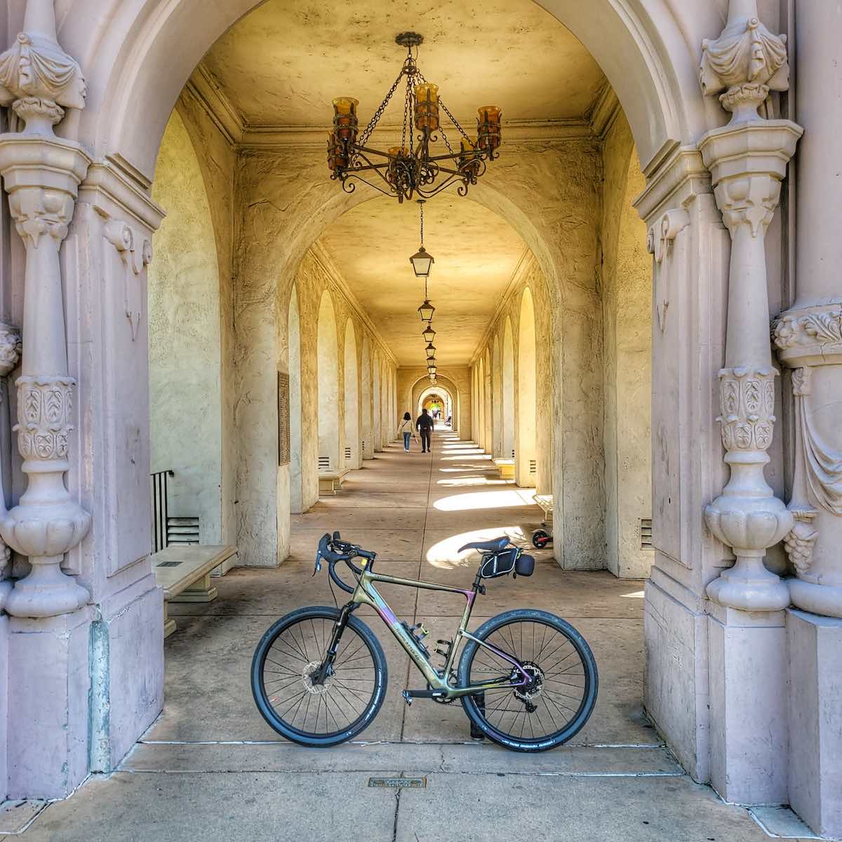 a bicycle sits in the entry way of an ornate balboa park in san diego california.