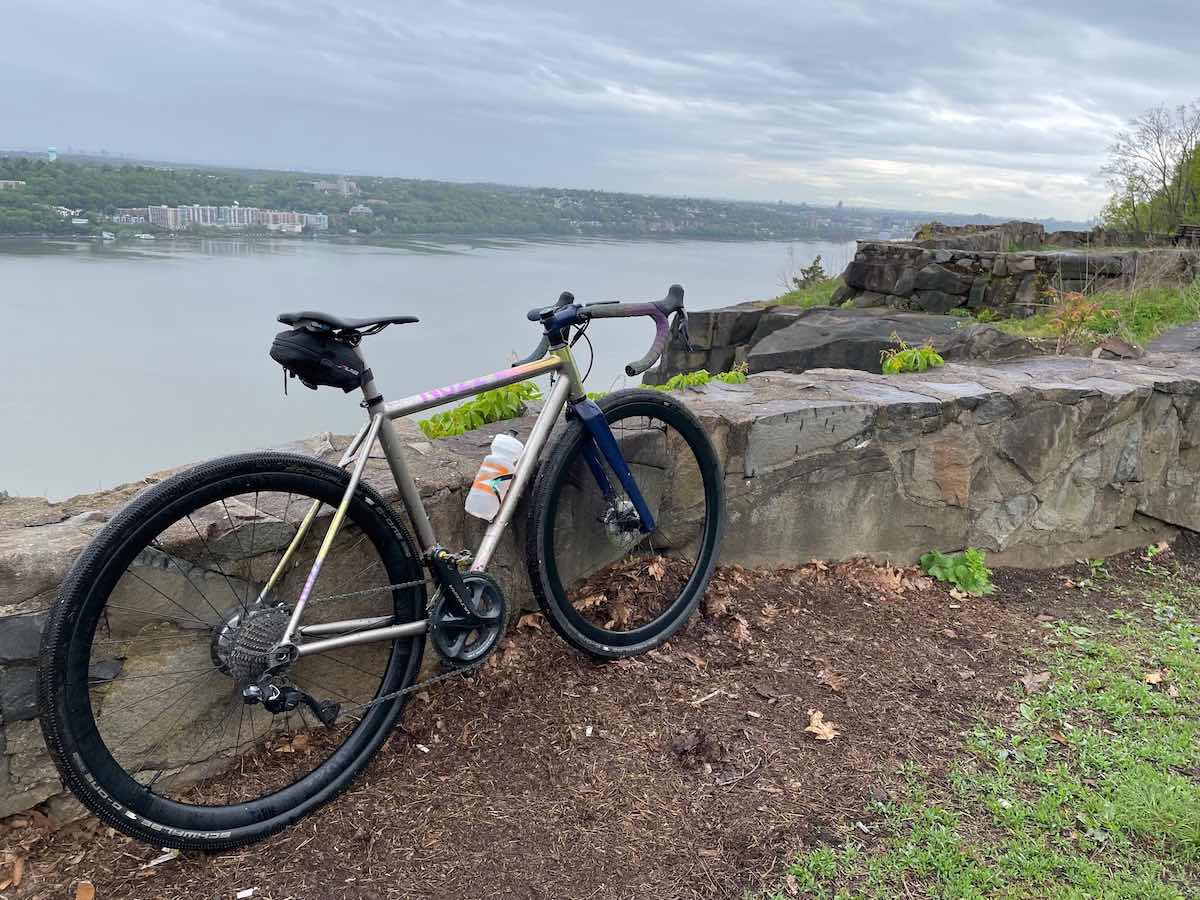 bikerumor pic of the day a no 22 drifter bicycle leans against a stone wall at palisades park overlooking a river with a small town on the other side.
