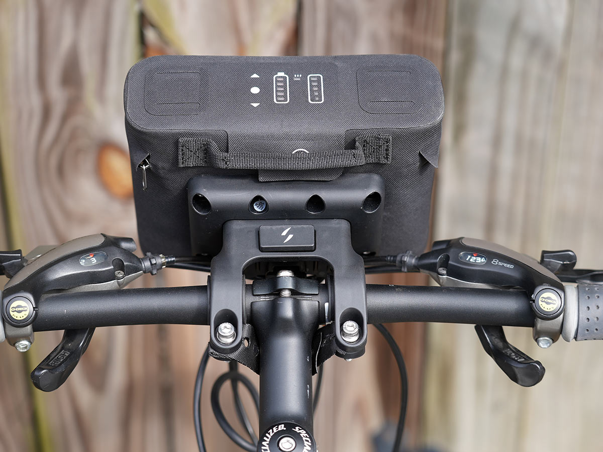 swytch e bike kit battery and control pack on a bicycle handlebar
