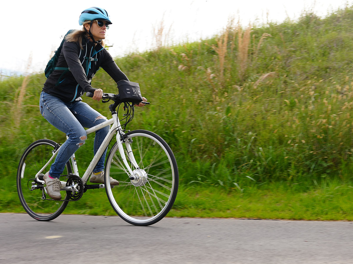 riding the swytch ebike conversion kit with front hub motor on a bike path