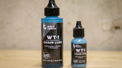 Wolf Tooth WT-1 Synthetic Chain Lube cleans, lubes, & protects in one blue/green bottle